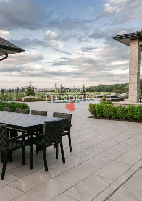 This cozy backyard entertainment area features a spacious paver patio and a refreshing pool, making it perfect for hosting gatherings. With ample seating and stylish decor, it creates a welcoming atmosphere for friends and family to enjoy.