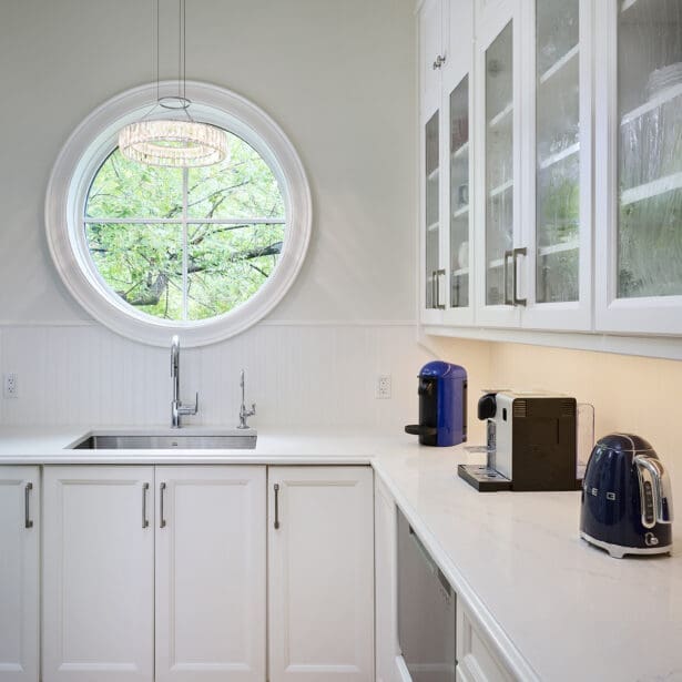 Interior view of a white butler's pantry, featuring ample storage, elegant cabinetry, and a clean, organized layout