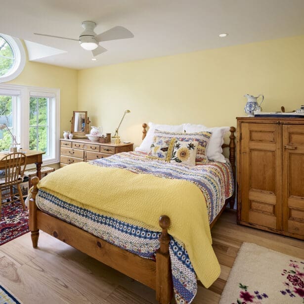 Interior view of a guest bedroom featuring a unique barreled dormer that adds architectural interest, along with cozy furnishings and inviting decor.