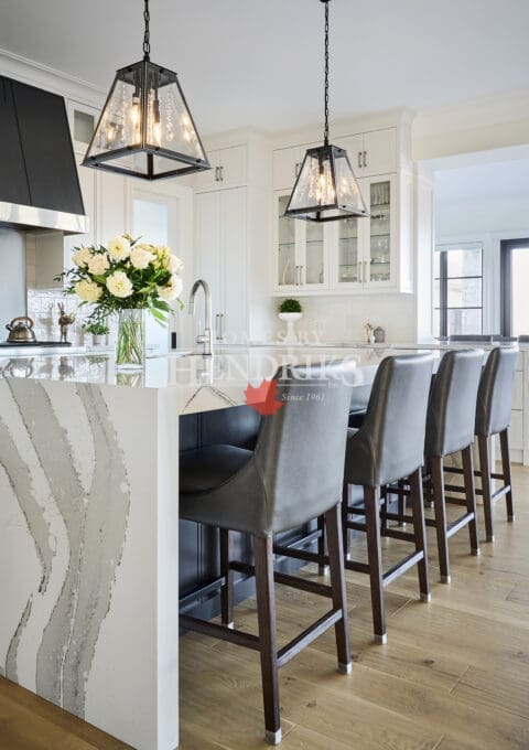 Close-up of the kitchen island featuring waterfall countertops and premium finishes.