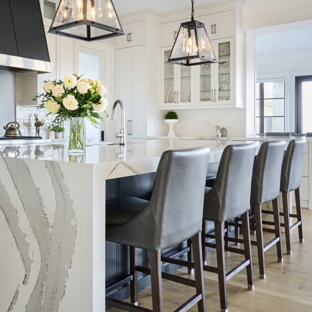 Close-up of the kitchen island featuring waterfall countertops and premium finishes.