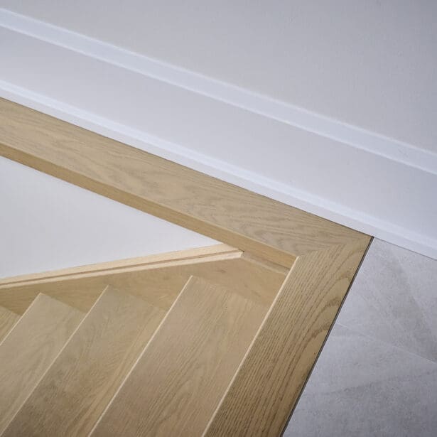 Close-up of the staircase showing refined railing craftsmanship and clean detailing.