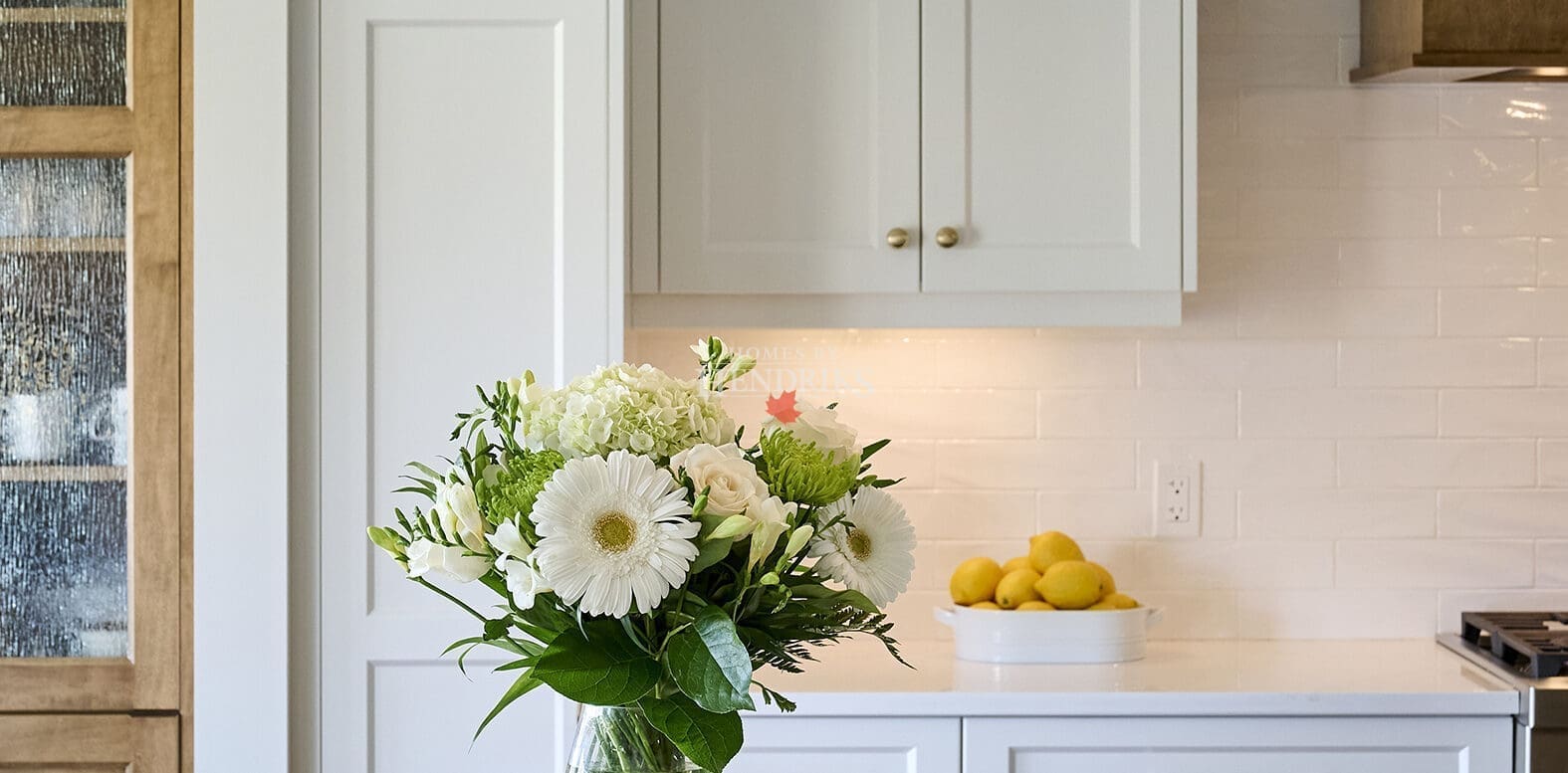 Custom two-tone maple cabinetry in the kitchen, featuring a rich blend of natural wood tones
