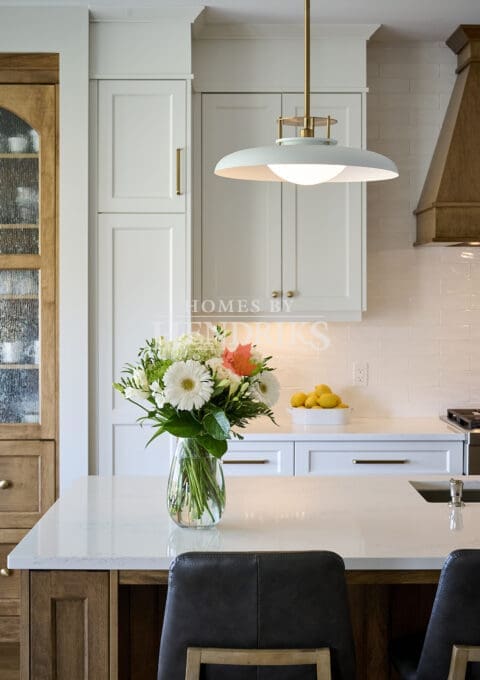 Custom two-tone maple cabinetry in the kitchen, featuring a rich blend of natural wood tones