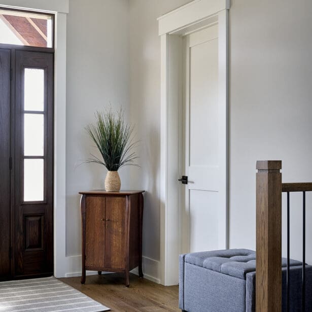 A welcoming entryway featuring a spacious, open design with rustic timber framing and elegant finishes.