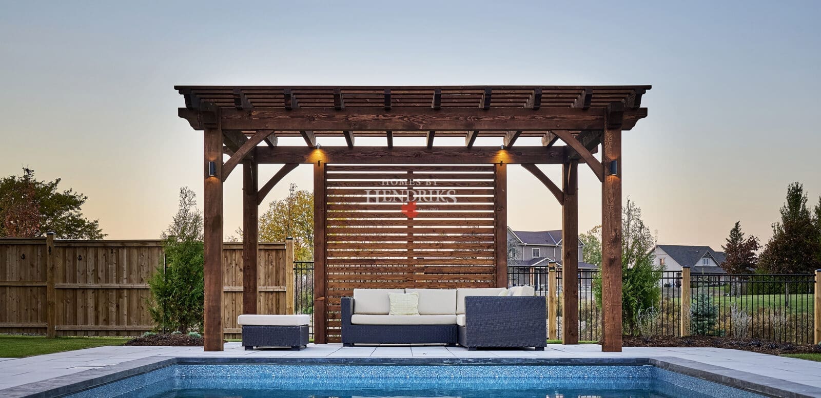 A stylish poolside pergola with rustic timber framing, providing shade and an elegant focal point near the pool.