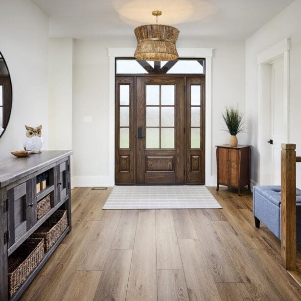 A welcoming front entryway featuring a custom wooden door with intricate detailing and rich, natural wood finishes.