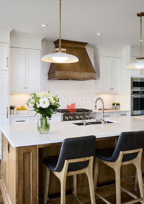 Custom two-tone maple cabinetry in the kitchen, combining warm, natural wood tones with a sleek, modern finish.