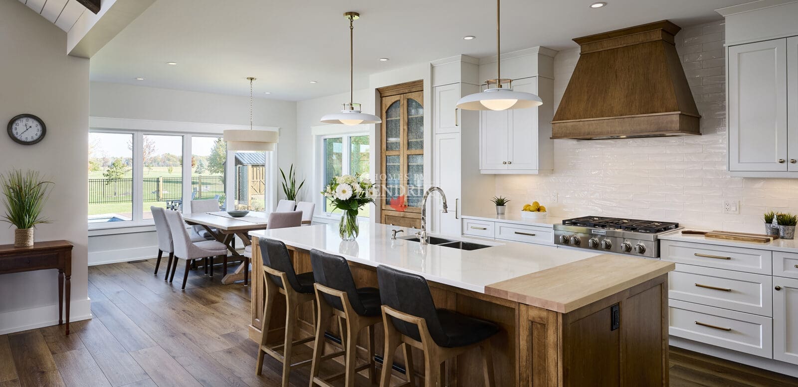 A large, custom kitchen island featuring contrasting wood tones that add visual interest and functionality.