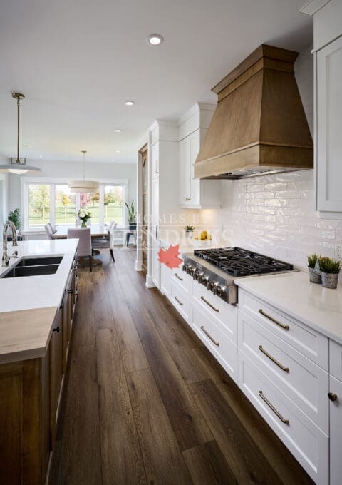 A beautifully designed kitchen featuring custom two-tone maple cabinetry that blends warm, natural wood tones with a sleek finish.