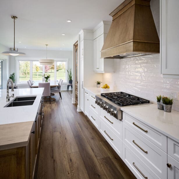 A beautifully designed kitchen featuring custom two-tone maple cabinetry that blends warm, natural wood tones with a sleek finish.