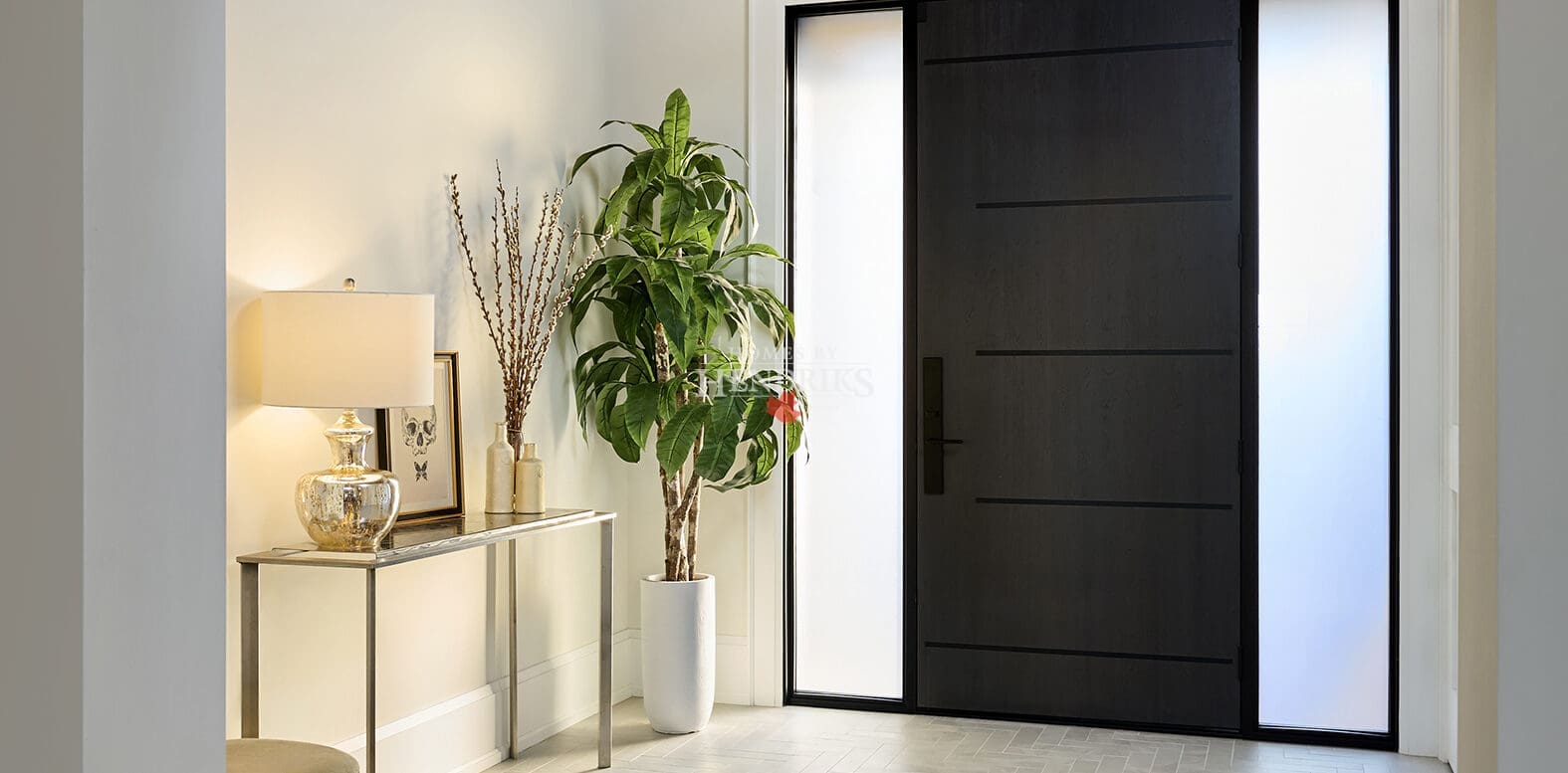 Bright front foyer with clean millwork, natural light, and a welcoming transitional design.