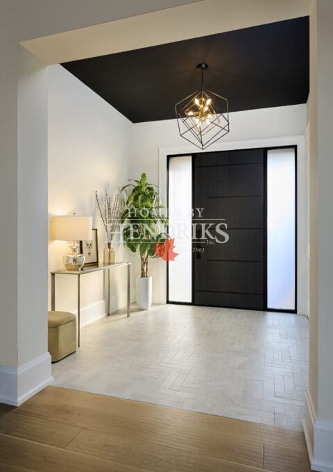 Bright front foyer with clean millwork, natural light, and a welcoming transitional design.