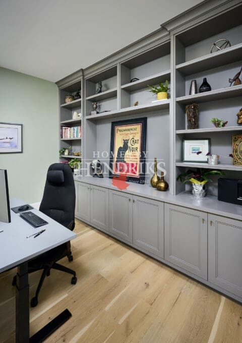 Private home office with built-in storage and natural light.