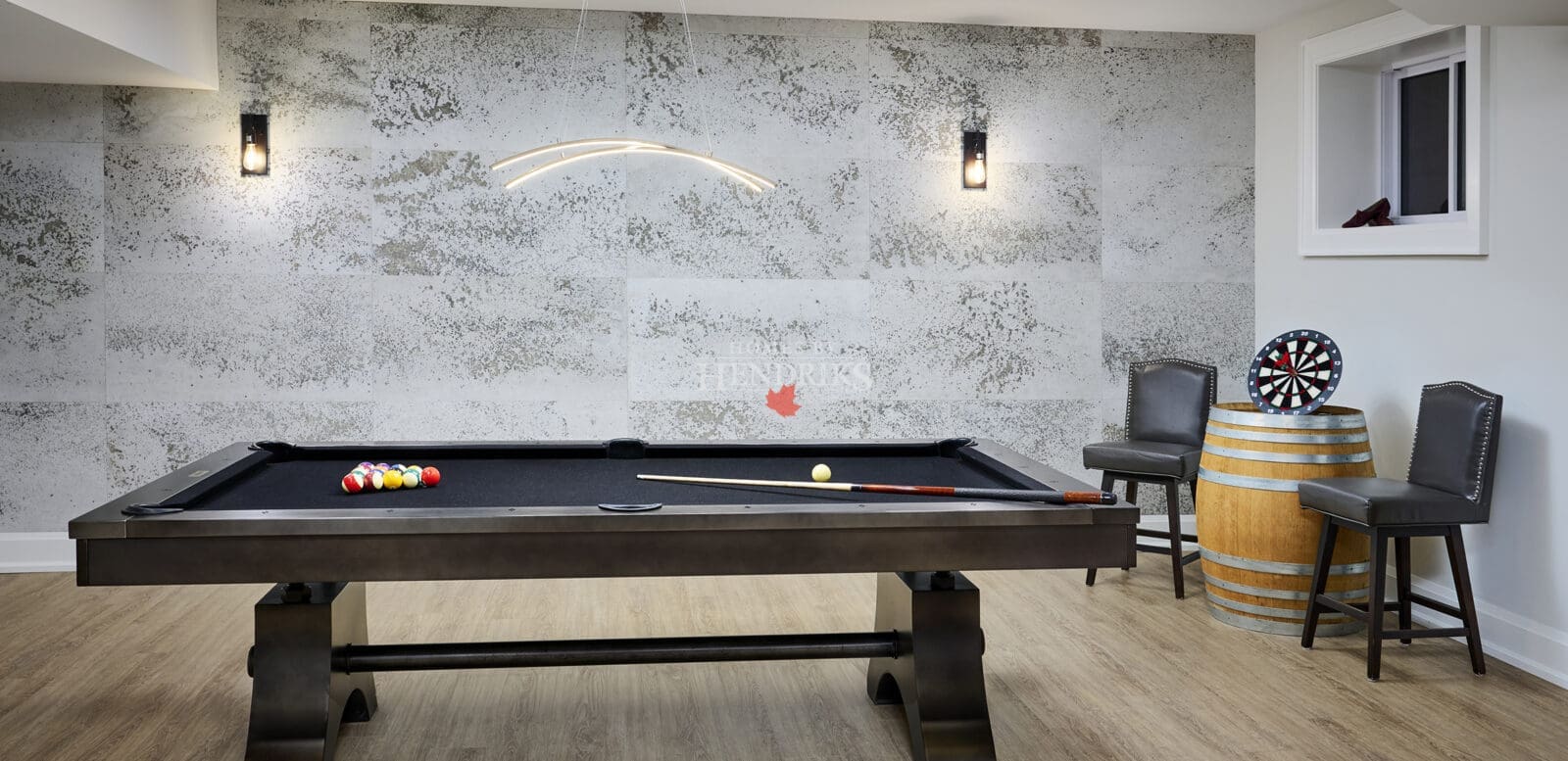 Recreation space featuring a modern pool table with coordinated lighting and seating.