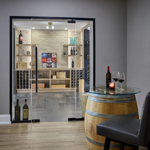 Glass-enclosed wine room with custom shelving and climate-controlled storage.