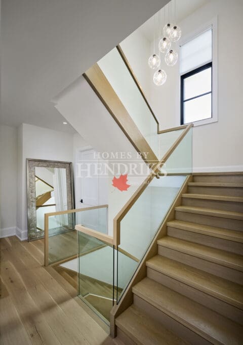 Modern staircase with clean railing details and bright natural light.