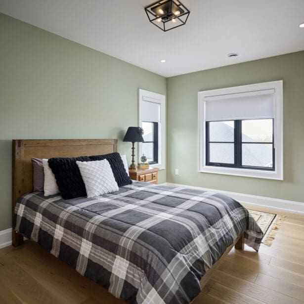 Guest bedroom with neutral tones and soft natural lighting.