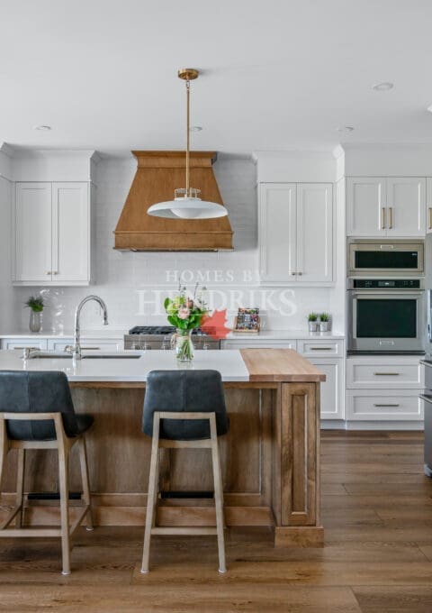 A beautiful kitchen featuring custom two-tone maple cabinetry, blending natural wood tones with a modern finish.