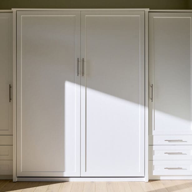 Mudroom floor-to-ceiling white cabinetry, light wood floors,