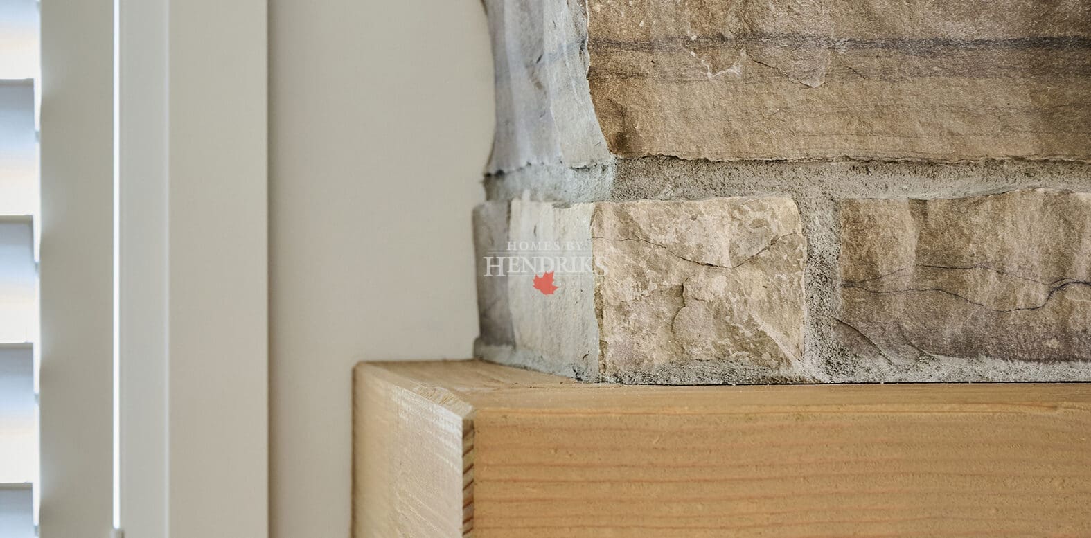 Timber fireplace mantle with natural stone cladding
