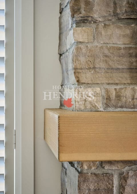 Timber fireplace mantle with natural stone cladding