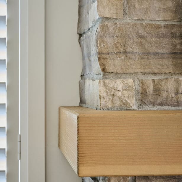 Timber fireplace mantle with natural stone cladding