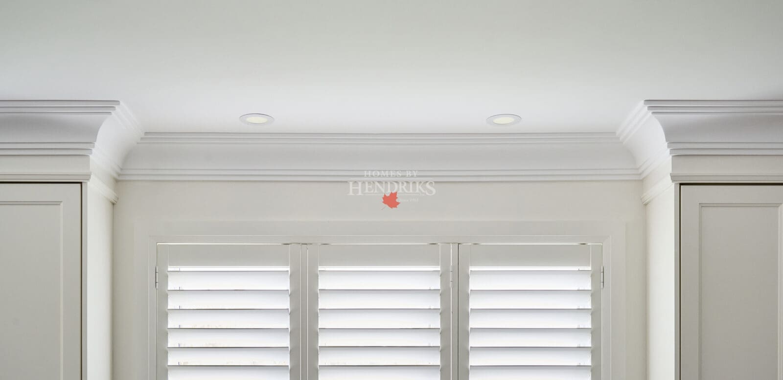 Smooth white trim, crown, and casing joinery detail highlighting craftsmanship and finishing quality.