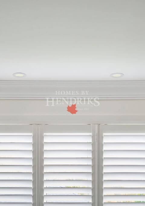 Smooth white trim, crown, and casing joinery detail highlighting craftsmanship and finishing quality.