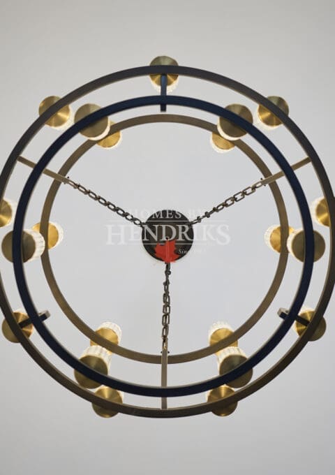 Contemporary double-ring chandelier with warm brass accents suspended from the ceiling, creating a striking modern focal point.