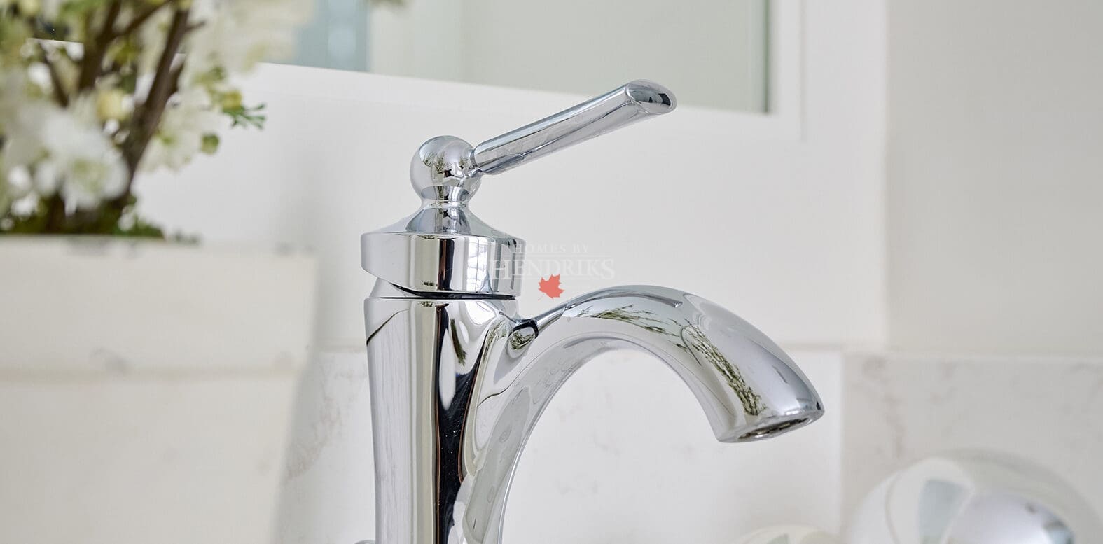 Elegant chrome single-handle bathroom faucet surrounded by minimalist décor and soft neutral tones