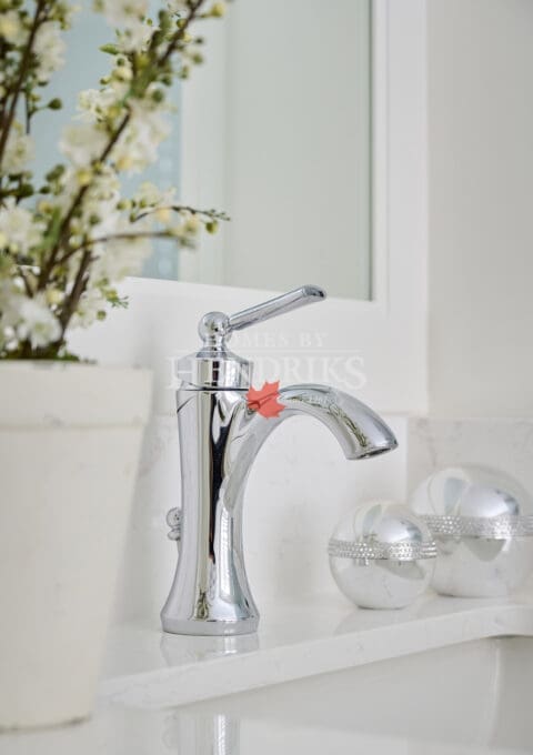 Elegant chrome single-handle bathroom faucet surrounded by minimalist décor and soft neutral tones