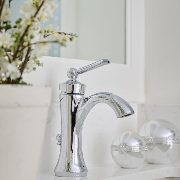 Elegant chrome single-handle bathroom faucet surrounded by minimalist décor and soft neutral tones