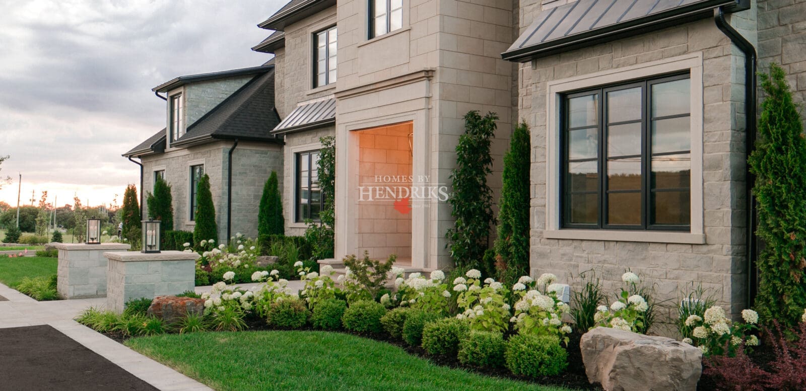 An attractive glimpse of the front doorway of a tailored custom residence, exterior view