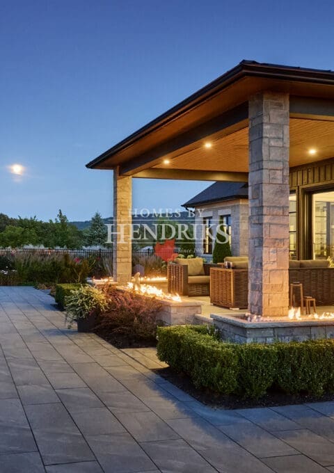 An inviting rear view of a backyard, blending stunning hardscaping with lush landscaping for a perfect outdoor space.